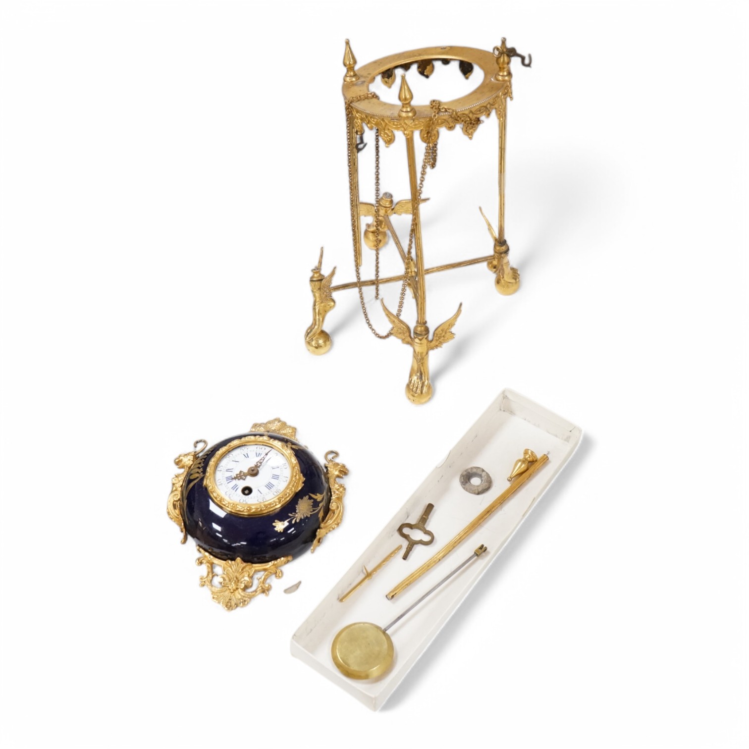 An unusual enamel and gilt brass timepiece, pendant from gilt brass frame, stand 26cm high. Condition - dismantled